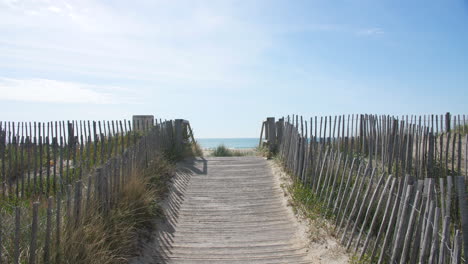 Path-to-the-mediterranean-sea-fix-shot-sand-dunes-vegetation-and-wood-fences